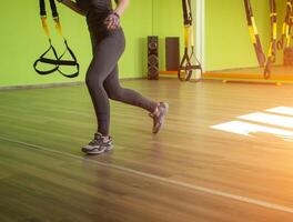 Lesson and exercise in a modern gym with loops, copy space, sun, excess weight, metabolic photo