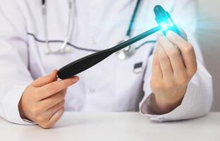A neurological hammer is in the hands of a neurologist. Concept for treating the nervous system, panic attacks and intervertebral hernias, testing reflexes, close-up photo