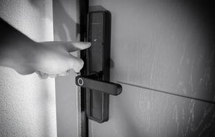 A thief is trying to break into an electronic door lock. A modern lock for entering with a client card or password, close-up photo