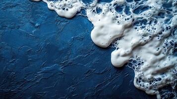 Foamy white waves spill over a deep blue surface, evoking the serenity of the ocean at dusk photo