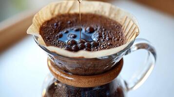 Drizzling hot water over freshly ground coffee in a rustic brew setup photo