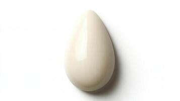 Beauty blender resting elegantly on a white surface showcasing its smooth curves and design photo