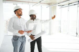 Group of multi ethnic engineer construction site worker meeting at workplace photo