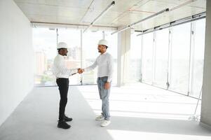 engineers team are discussing while inspecting at construction site photo