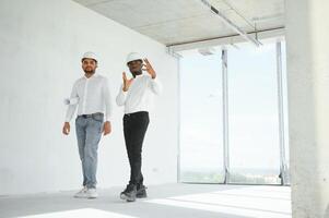 engineers team are discussing while inspecting at construction site photo
