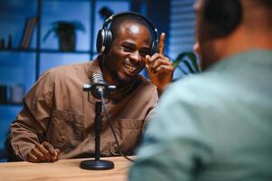 Podcast presenter having live discussion with man, streaming it for audience on internet entertainment show. Influencer enjoying chat with guest photo