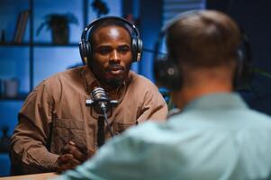 Podcast presenter having live discussion with man, streaming it for audience on internet entertainment show. Influencer enjoying chat with guest photo