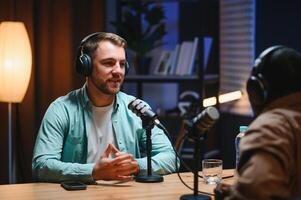 Podcasters enjoying happy conversations with online listeners in studio, covering wide range of subjects photo