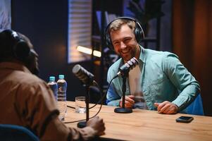 Podcasters enjoying happy conversations with online listeners in studio, covering wide range of subjects photo