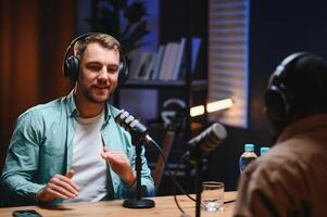 Man recording podcast using high tech microphones to interview guest, ensuring flawless and sound quality for audience photo