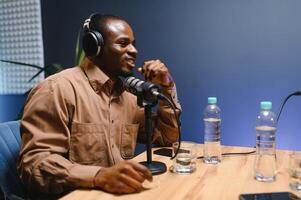 Man recording podcast using high tech microphones to interview guest, ensuring flawless and sound quality for audience photo