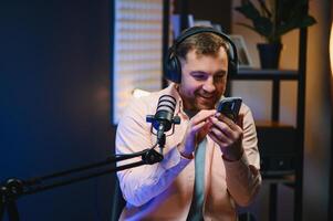 Man smiling while recording podcast in studio photo