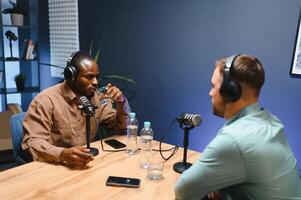 Podcasters enjoying happy conversations with online listeners in studio, covering wide range of subjects photo