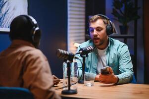 Podcasters enjoying happy conversations with online listeners in studio, covering wide range of subjects photo