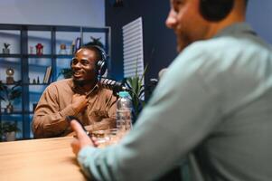 Podcasters enjoying happy conversations with online listeners in studio, covering wide range of subjects photo