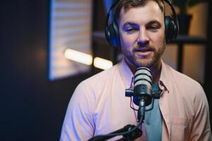 Man smiling while recording podcast in studio photo