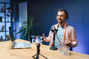 Man smiling while recording podcast in studio photo