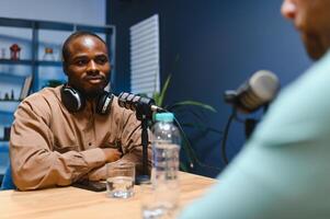 Podcast presenter having live discussion with man, streaming it for audience on internet entertainment show. Influencer enjoying chat with guest photo