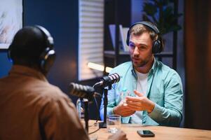 Podcast presenter having live discussion with man, streaming it for audience on internet entertainment show. Influencer enjoying chat with guest photo