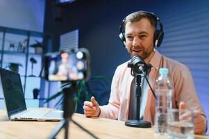 Man smiling while recording podcast in studio photo
