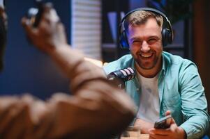Man recording podcast using high tech microphones to interview guest, ensuring flawless and sound quality for audience photo