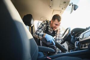 Feeling happy to be doing an excellent job at my job at the car wash. Portrait of a man while sitting inside a customer vehicle photo