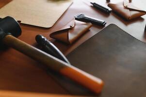 Crafting tools on natural cow leather in the tailoring workshop. Top view photo