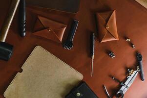 Crafting tools on natural cow leather in the tailoring workshop. Top view photo