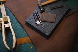 Crafting tools on natural cow leather in the tailoring workshop. Top view photo
