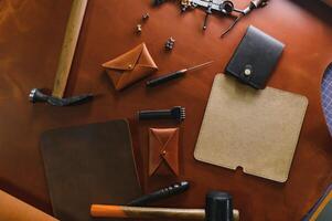 Crafting tools on natural cow leather in the tailoring workshop. Top view photo