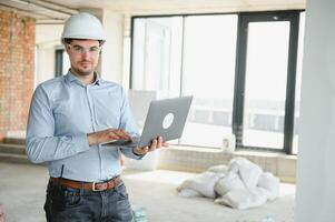 Man builder. Architect at construction site photo