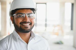 Construction concept. Portrait of a young architect at a construction site photo