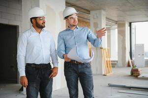 two architect engineers are walking in a constructed office building. implementation of the project photo