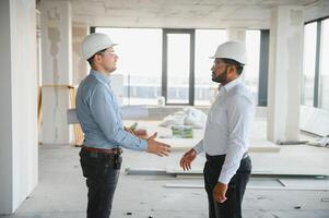two architect engineers are walking in a constructed office building. implementation of the project photo