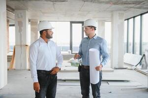 two architect engineers talking in a constructed office building photo