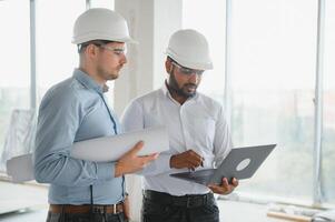 two architect engineers are walking in a constructed office building. implementation of the project photo