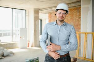 Man builder. Architect at construction site photo