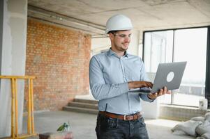 Man builder. Architect at construction site photo