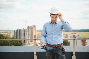 Man builder. Architect at construction site photo