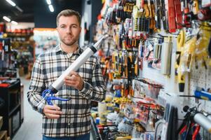 Portrait of mature man standing in hardware store photo