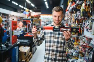Male buyer in a modern hardware store water level photo