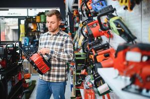 A man in a hardware store choosing a tool photo