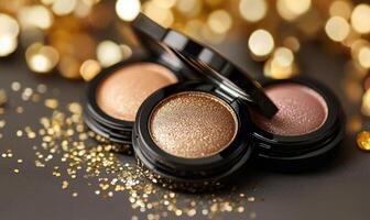 A set of eyeshadows warm champagne, soft peach, rich bronze, and deep plum, with a light sprinkling of golden confetti photo