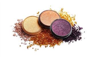 A collection of eyeshadows rich copper, dusty mauve, deep plum, and soft peach, lightly decorated with golden tinsel photo