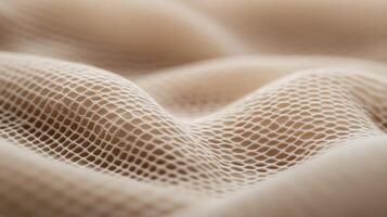 Fabric texture with a fine mesh pattern in soft tones photo
