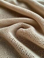Soft beige fabric with intricate mesh pattern on display photo