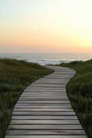Serene wooden pathway leading to the ocean at sunset photo