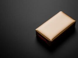 Elegant gold wrapped package on a dark surface photo