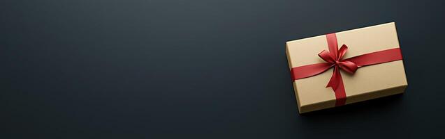 Gift box with red ribbon on dark background photo