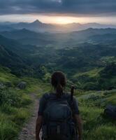 Hiker enjoying panoramic view during sunset in a mountain valley photo